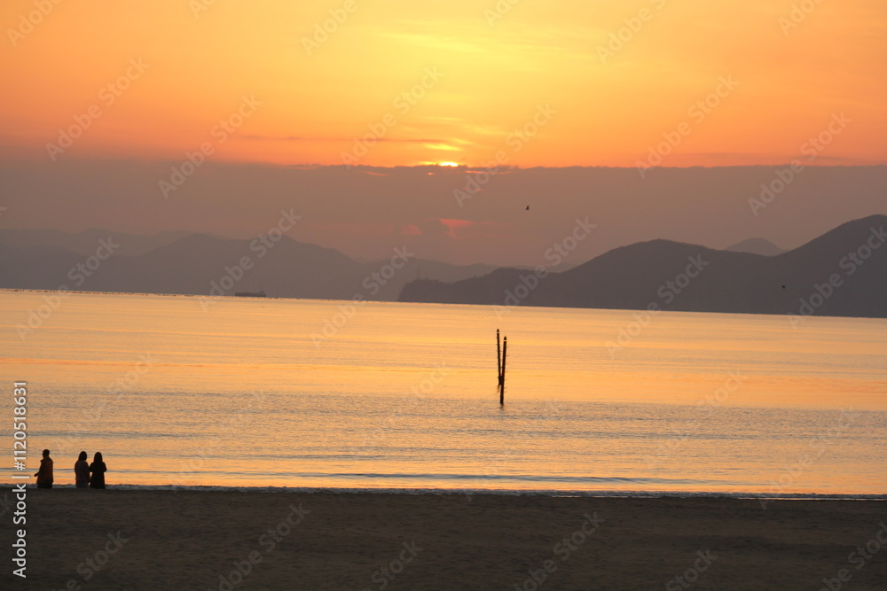 Image of people enjoying a beautiful sunset at Dadaepo Beach in Busan and a landscape image of sunset at sea
Image of people enjoying a beautiful sunset at Dadaepo Beach in Busan and a landscape image of sunset at sea