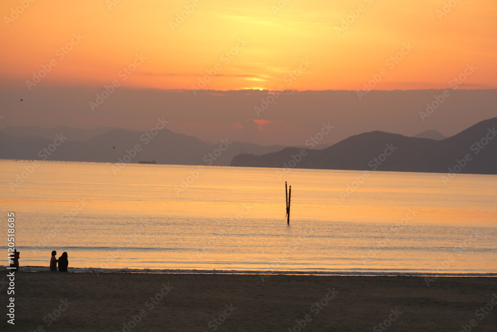 Image of people enjoying a beautiful sunset at Dadaepo Beach in Busan and a landscape image of sunset at sea
Image of people enjoying a beautiful sunset at Dadaepo Beach in Busan and a landscape image of sunset at sea