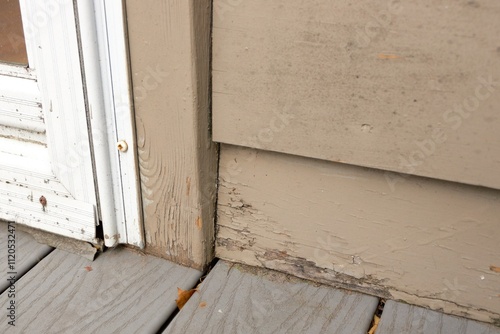 Wood Siding on House shows peeling and cracked painting and early signs of decay and rot