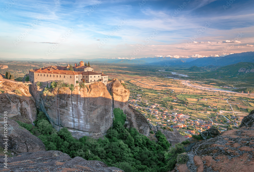 Obraz premium The Nunnery of St. Stephen, an Eastern Orthodox monastery in Meteora, Thessaly, central Greece, with Kalambaka in the background