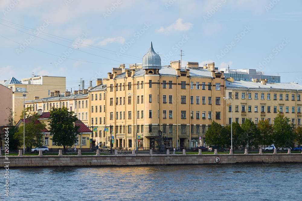 A Charming Historic Building Gracefully Positioned by the Serene Riverbank in an Urban Landscape A Charming Historic Building Gracefully Positioned by the Serene Riverbank in an Urban Landscape