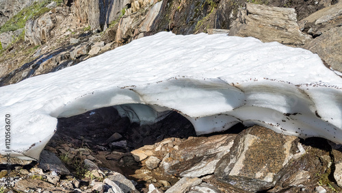 Frozen snow layer archiFrozen snow layer arching over a small creekng over a small creek