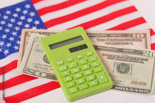 USA American flag, green calculator and dollars. Sustainability Calculating expenses concept. inflation, economic, income, budget, financial planning