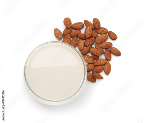 Glass of almond milk and nuts isolated on white, top view photo