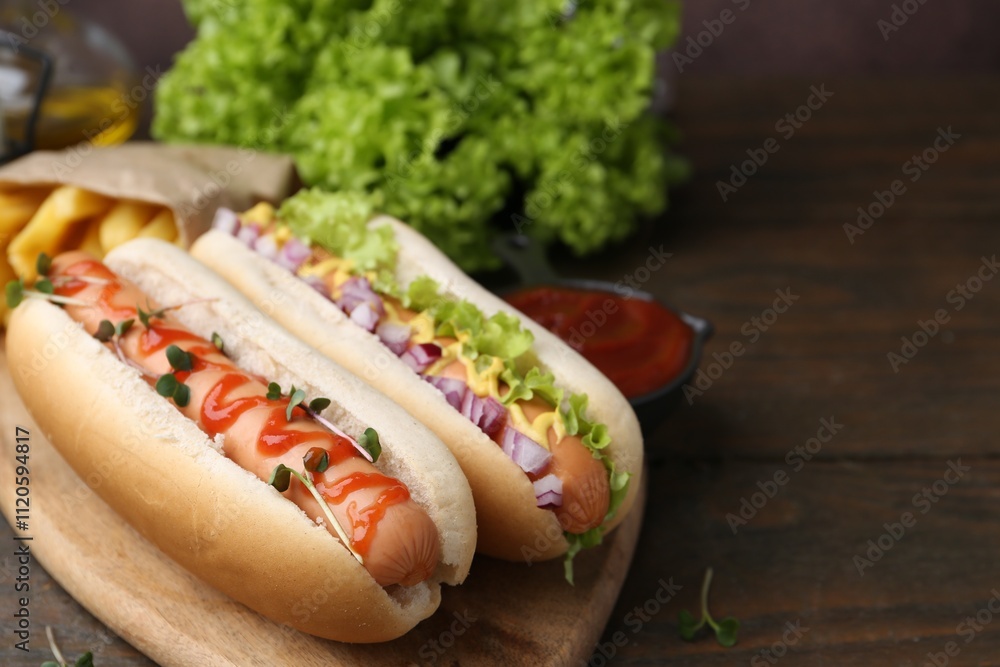 Tasty hot dogs served on wooden table, closeup. Space for text Tasty hot dogs served on wooden table, closeup. Space for text