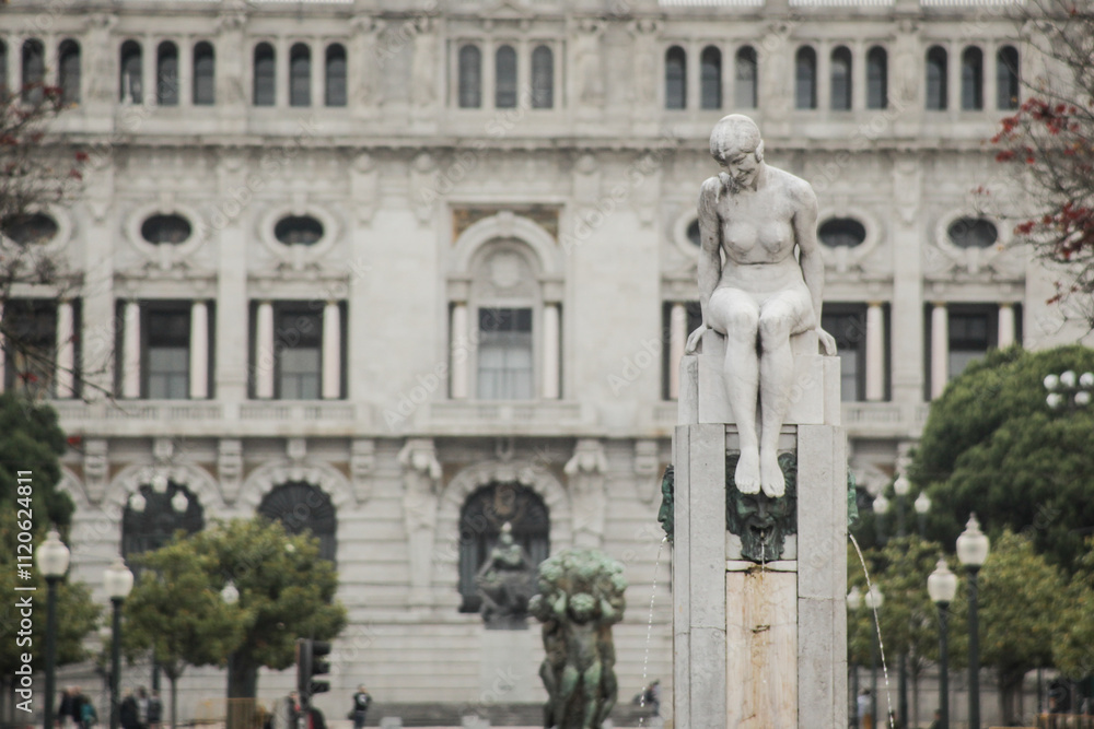 Fototapeta premium Statue on Avenue of Aliados in the city of Porto, Portugal. Beautiful avenue in the city centre, looking towards the city hall...