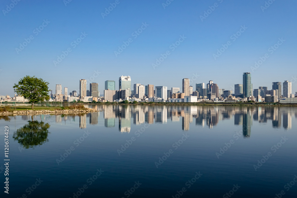 Fototapeta premium Urban landscape of Osaka City Viewed from Yodogawa Riverside (Tsukamoto)
