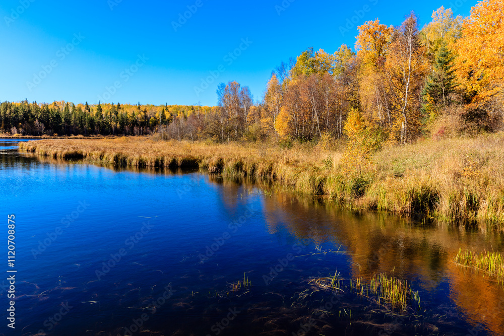A lake with a blue sky in the background A lake with a blue sky in the background