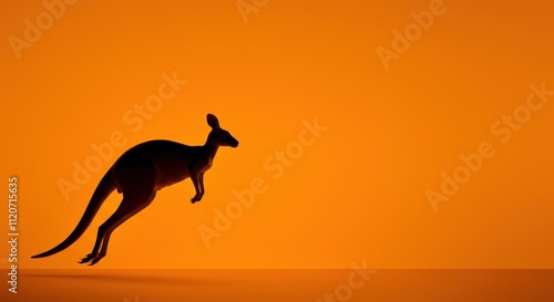 Silhouette of kangaroo mid-jump against orange background