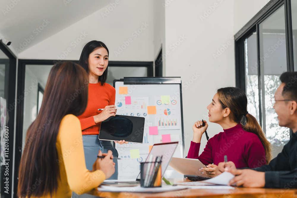 woman presenting ideas to team in modern office