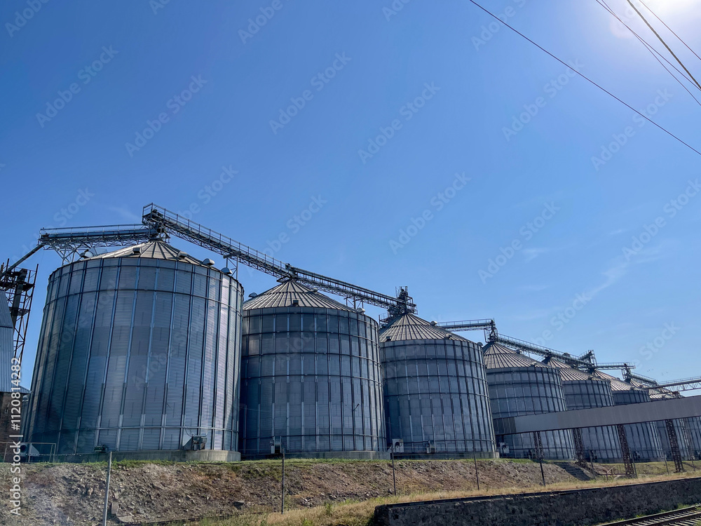 Structures of metal silos for grain that reach a height on a farm Structures of metal silos for grain that reach a height on a farm