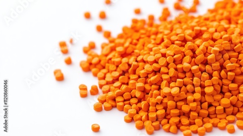 Orange masterbatch granules in various sizes isolated on a clean white background, accompanied by a vibrant color chip, industrial, manufacturing, plastic materials, additives.
