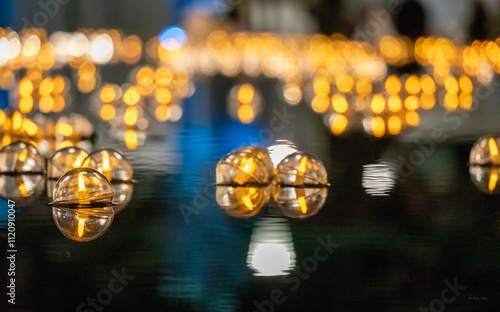 Golden lanterns on lake in the night reflections Temple Square SLC Utah photo