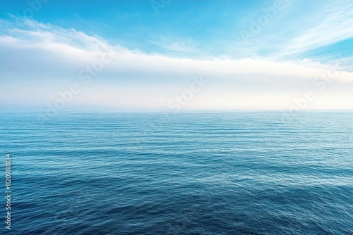 A serene view of calm ocean waters under a bright blue sky.