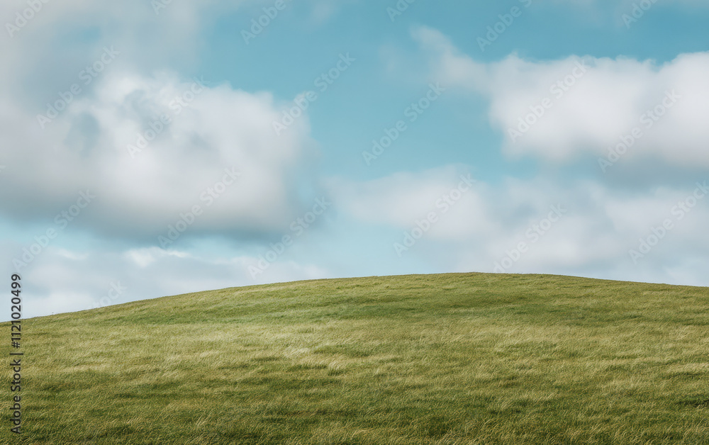 Rolling green hill under a cloudy sky in a serene countryside landscape Rolling green hill under a cloudy sky in a serene countryside landscape