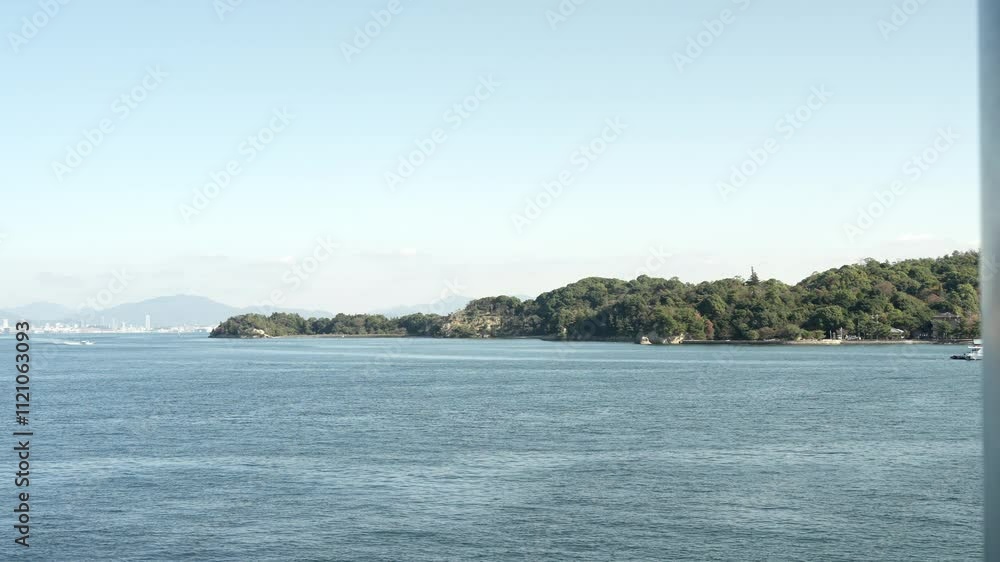 The view of Itsukushima island from a ferry in Hiroshima, Japan. The view of Itsukushima island from a ferry in Hiroshima, Japan.