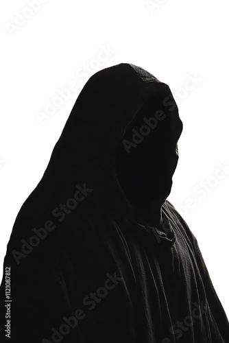 Silhouette of a hooded person in darkness. photo