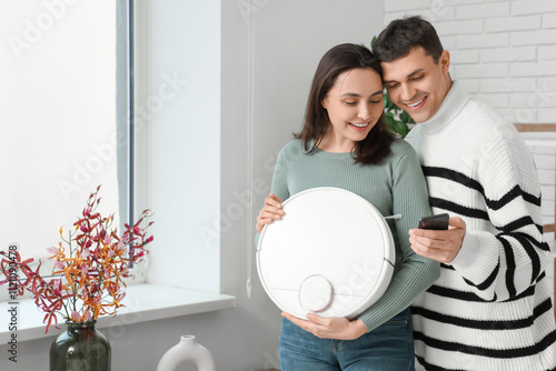 Happy couple holding robot ...