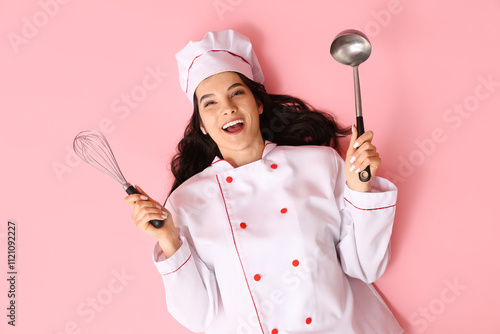 Happy young female cook wit...