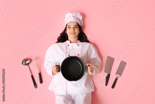 Happy young female cook wit...