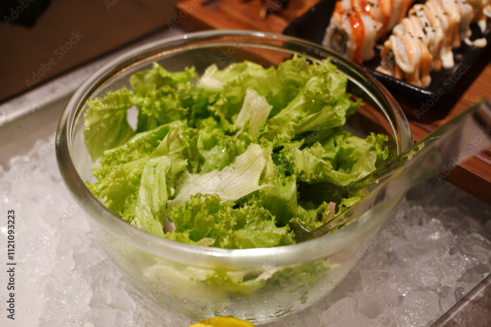 Salad and rolls in a glass bowl on the counter of a restaurant Salad and rolls in a glass bowl on the counter of a restaurant