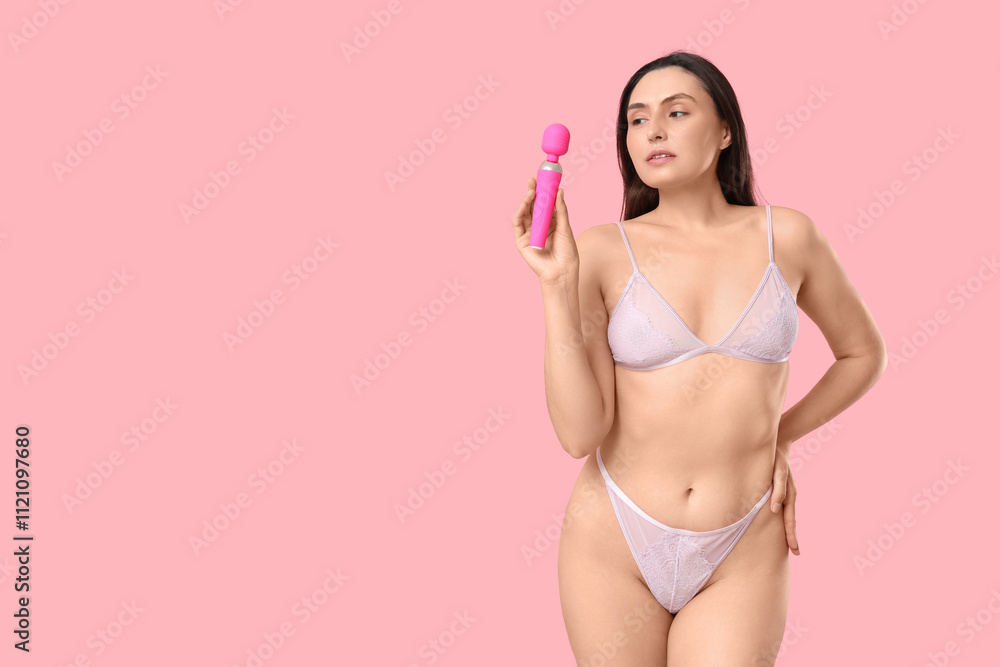 Naklejka premium Beautiful young woman in underwear with vibrator from sex shop on pink background