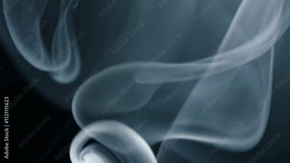 Abstract swirling smoke patterns on a dark background, creating an ethereal atmosphere. Abstract swirling smoke patterns on a dark background, creating an ethereal atmosphere.