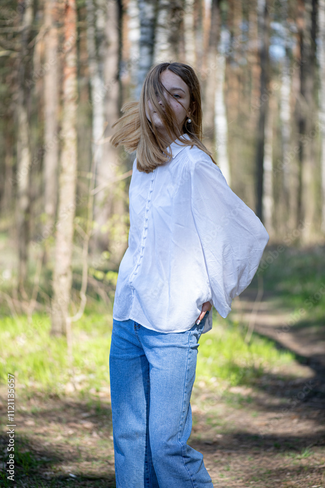 Young beautiful girl in a white shirt in the forest. Young beautiful girl in a white shirt in the forest.