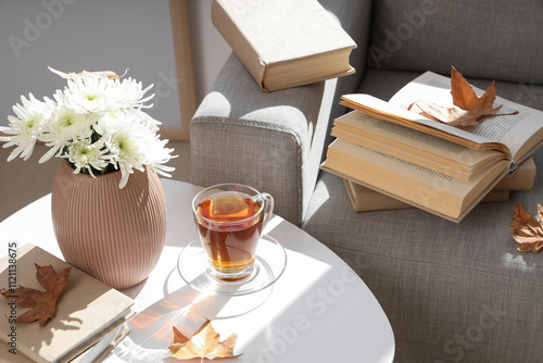 Cup of hot tea, books, autu...