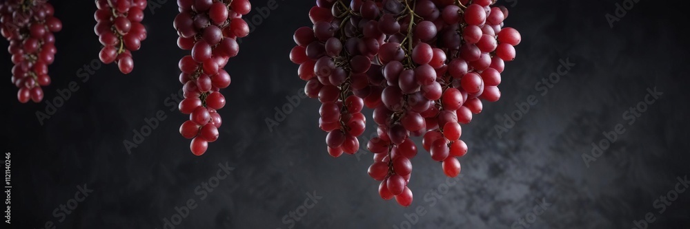 Fototapeta premium Dark background with suspended red grapes, evoking a sense of weightlessness and serenity, ambient, tranquility