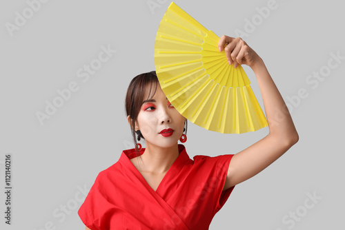 Young asian woman in red ki...