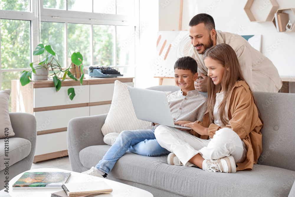 Cute little children with their father using laptop at home Cute little children with their father using laptop at home