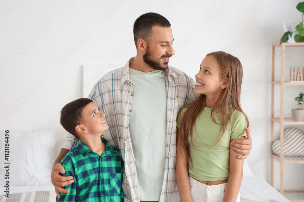 Cute little children with their father in bedroom Cute little children with their father in bedroom