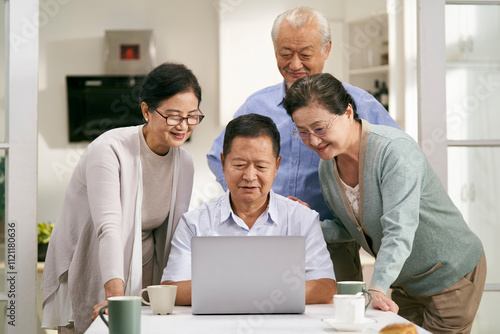 group of happy asian people two couples using laptop together indoors at home