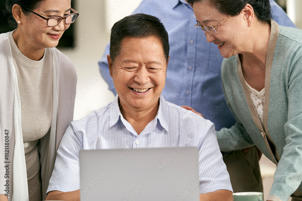 group of happy asian people two couples using laptop together indoors at home group of happy asian people two couples using laptop together indoors at home