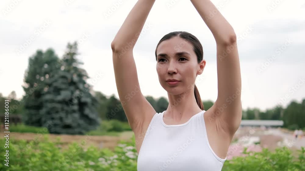 Calmness radiates from a woman practicing yoga poses in a serene park, fostering wellness and mindfulness in a tranquil environment Calmness radiates from a woman practicing yoga poses in a serene park, fostering wellness and mindfulness in a tranquil environment