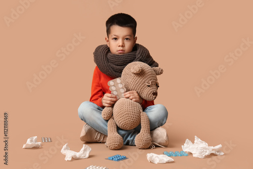 Ill little Asian boy with t...