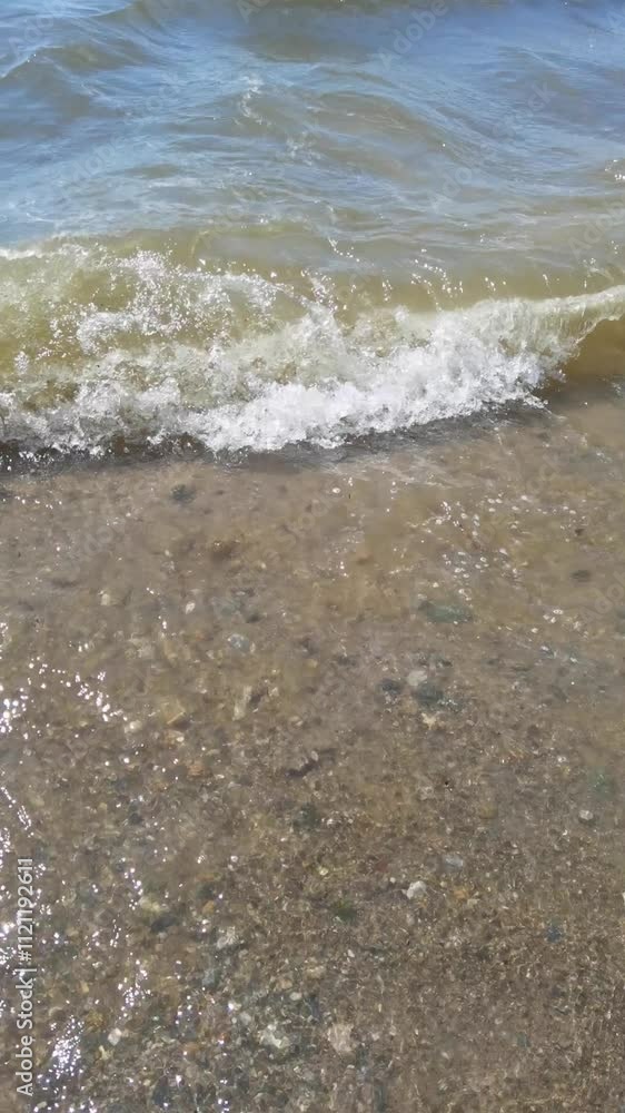 Dynamic ocean wave progression and interaction with sandy beach environment in bright sunlight. Dynamic ocean wave progression and interaction with sandy beach environment in bright sunlight.