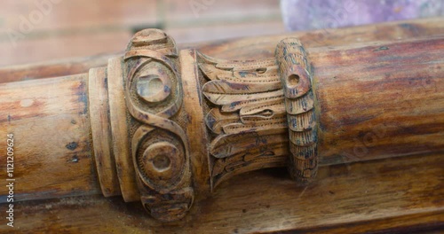 Fine wood carving in a restorer's workshop. Details of the vertical post of a carved ancient wooden door frame. Slow motion zoom in 4k footage.