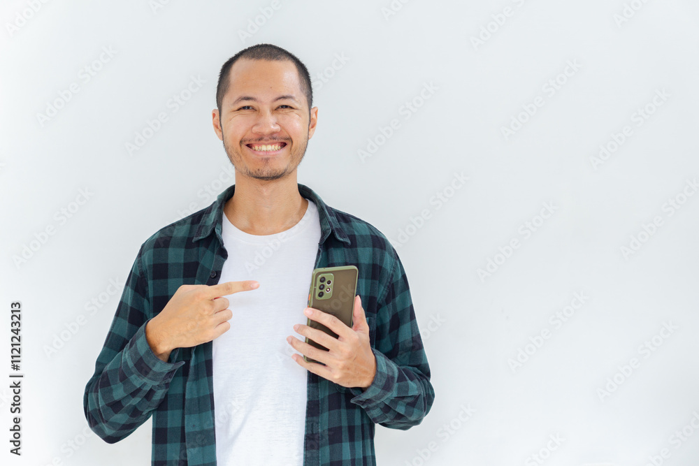 Young asian men with flannel and shirt is pointing to smartphone with happy expression in isolated white background