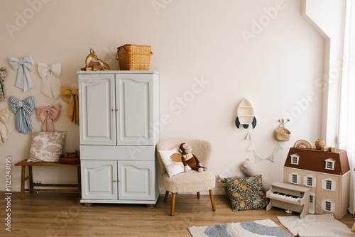 Obraz na płótnie Children room with white wall and colorful bows hanging on the wall. Small toy house is on the right side w salonie
