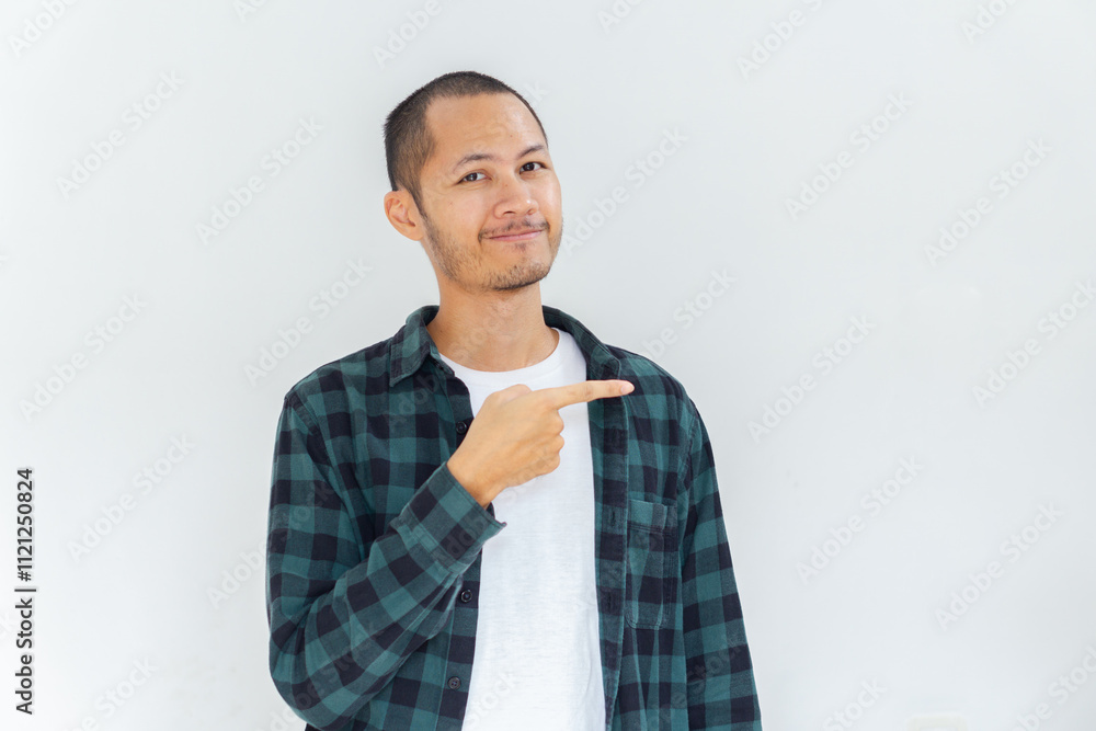 Young Adult Asian men wearing flannel and shirt pointing finger to the right with smiling face and exited expression with isolated white background Young Adult Asian men wearing flannel and shirt pointing finger to the right with smiling face and exited expression with isolated white background