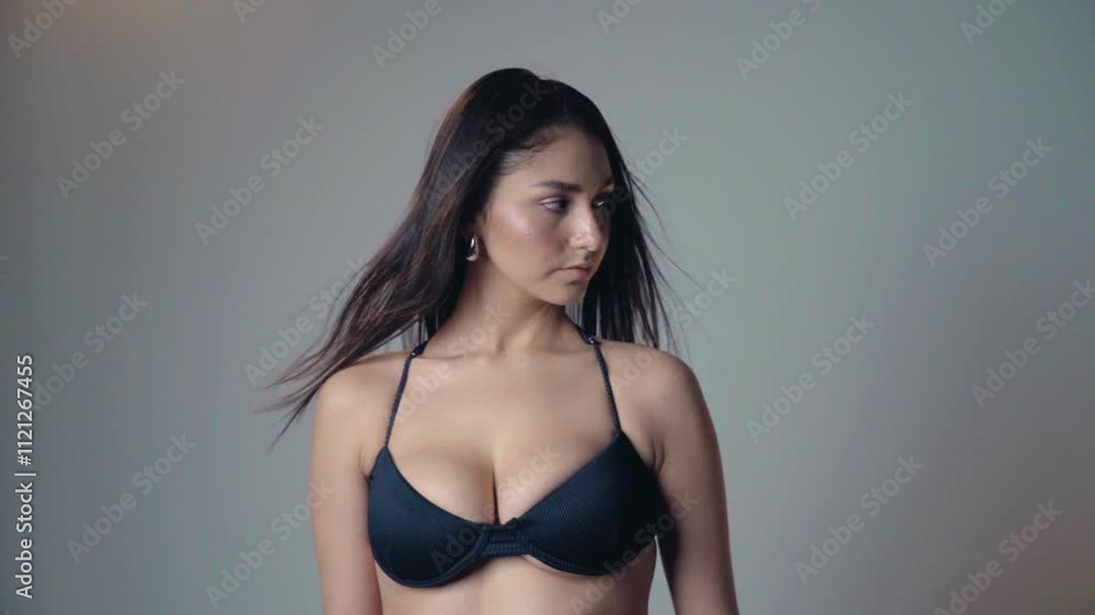 Beautiful Latin girl in lingerie hair being blown in slow motion looking at the camera cool Beautiful Latin girl in lingerie hair being blown in slow motion looking at the camera cool