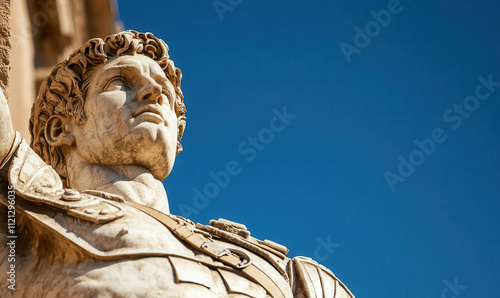 Majestic Stone Statue Against Clear Blue Sky Highlighting Detailed Carvings and Artistic Craftsmanship photo