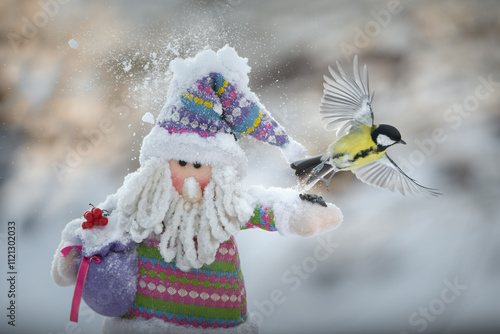 Emotional beautiful picture with Santa Claus and titmouse. Frosty sunny day. photo