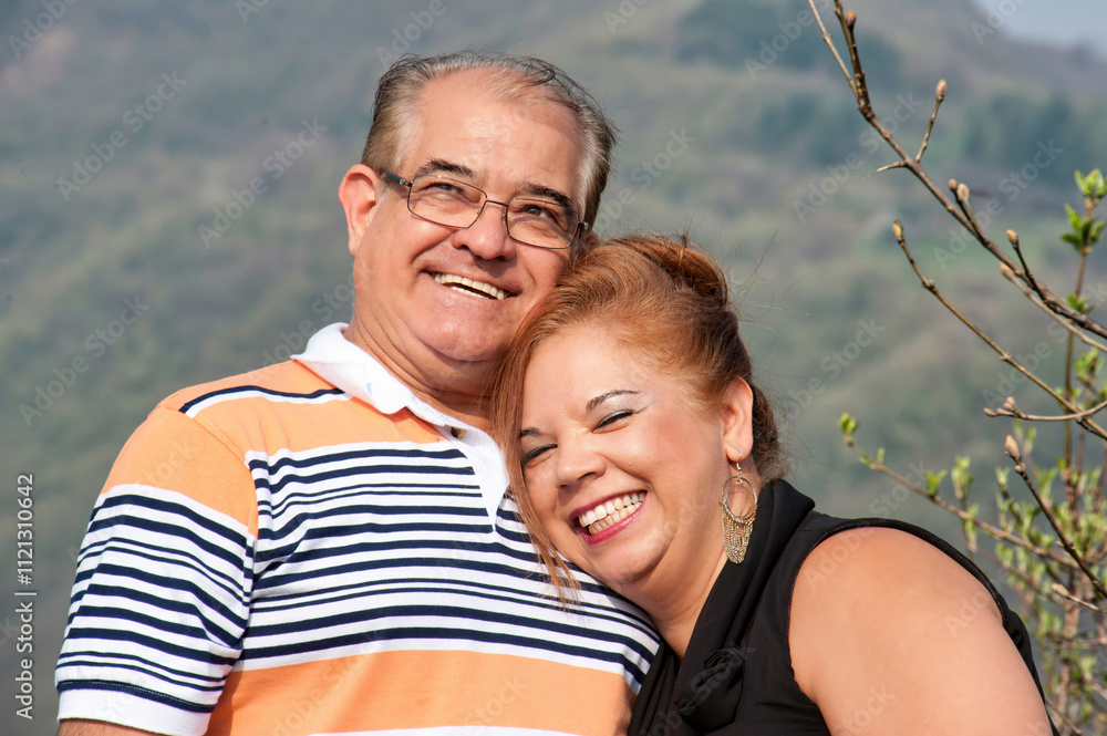 Close-up of a middle-aged couple hugging and smiling Close-up of a middle-aged couple hugging and smiling