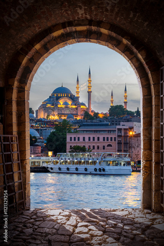 Istanbul city view with a mosque from an old stone door. photo