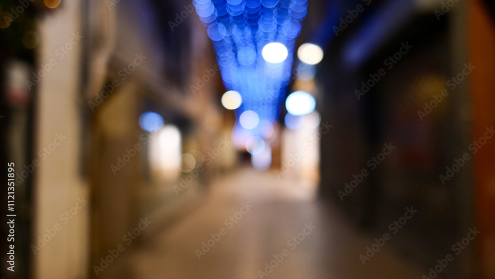 Fototapeta premium Festive garlands out of focus, street decoration, bokeh, night photography, France, Perpignan