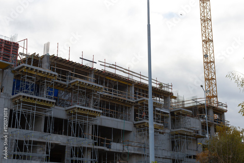 Wallpaper Mural A significant large building is currently under construction, prominently featuring a crane in the background assisting with the work Torontodigital.ca