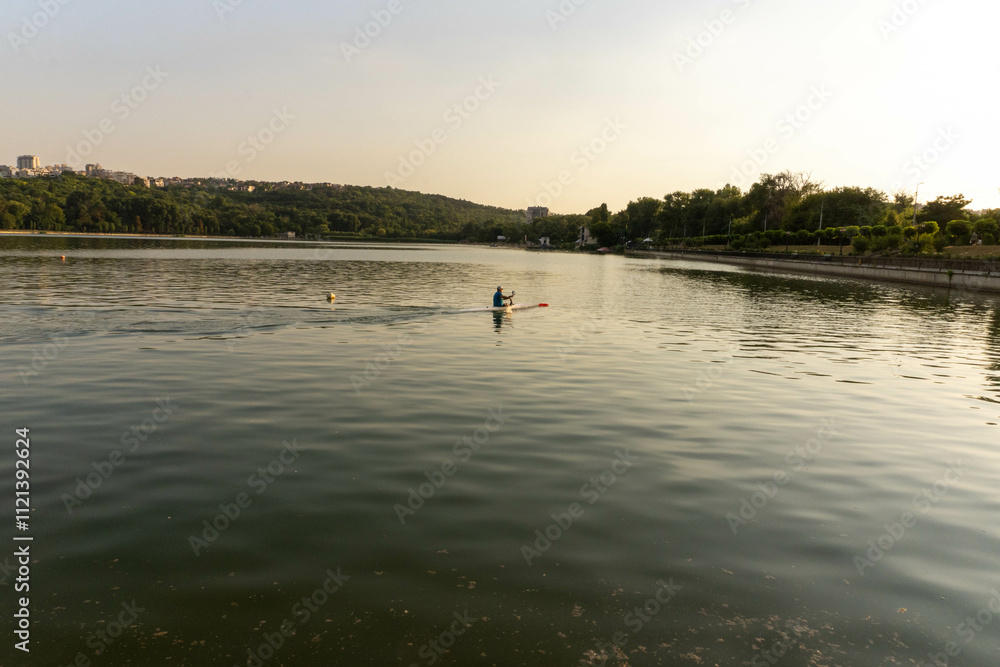A small lake where kayaks are paddling A small lake where kayaks are paddling